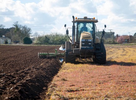 Challenger tracked tractor ploughing and pressing the soil in an arable field, Butley, Suffolk,