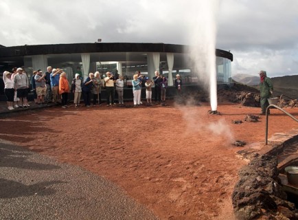 Tourists watch steam rise from geyser spout, Parque Nacional de Timanfaya, national park,