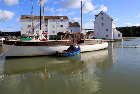 Historic boat and Tide Mill on the waterfront, River Deben, Woodbridge, Suffolk, England, UK