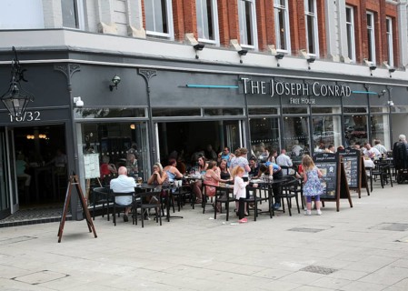 People sitting outside The Joseph Conrad Wetherspoons pub, Lowestoft, Suffolk, England, United