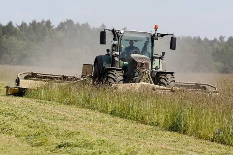 A tractor mows grass for the forage harvest, Müncheberg, 02/06/2020