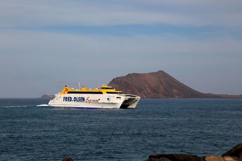 Fred Olsen Express ferry ship passing Los Lobos island, Corralejo, Fuerteventura, Canary Islands,