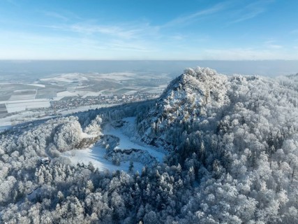 Aerial view of the snow-covered Hegau volcano Hohenstoffeln, with the former basalt quarry,