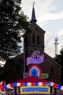 Cranger Kirche behind the Creperie and in front of the giant chain plane, Cranger Kirmes, Herne,