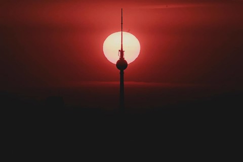 The sunrise emerges behind the city skyline with the television tower in Berlin, 04/09/2024
