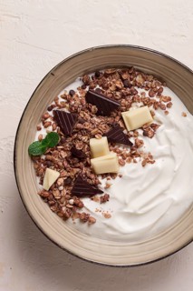 Yogurt with chocolate muesli, breakfast, close-up, fork on top, no people