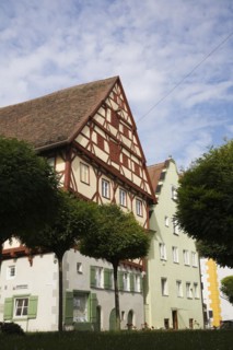 Multi storied apartment buildings with traditional terracotta ceramic tiled rooftops in medieval