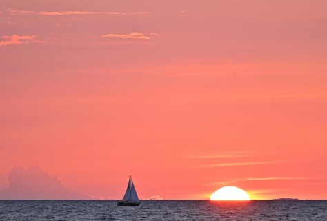 Sailboat sailing in the evening towards the setting sun, Baltic Sea, Poel Island,