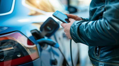A man is charging his electric car, AI generated