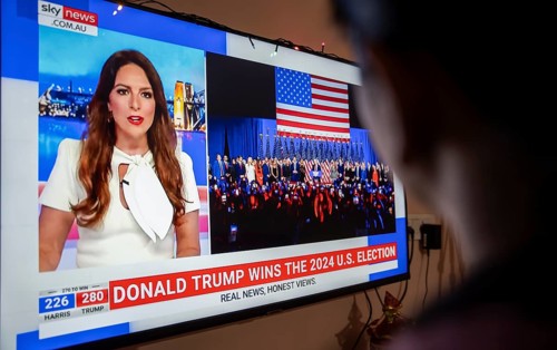 In this photo illustration, a person watch results of U.S. elections on a television in Guwahati,