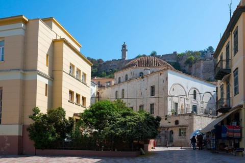 View of historic building with dome and fortress in the background under a clear sky, Agha Pasha