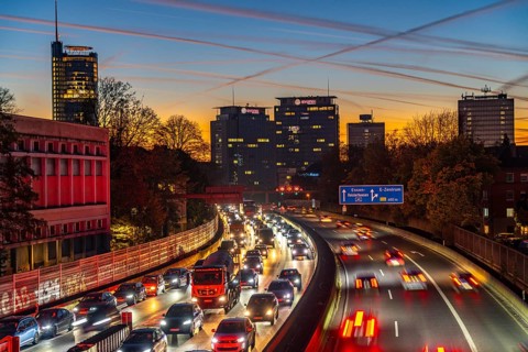 Evening traffic, partly with traffic jams, slow-moving traffic on the A40 motorway, skyline of