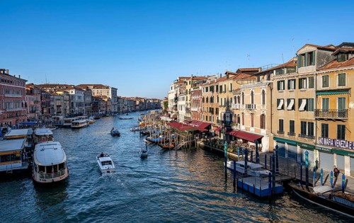View of the Grand Canal with water taxis and vaporetto in the evening light, view from the Rialto