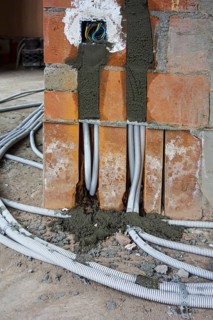 Electric wires, electrical cables, wiring on the floor to electrical outlets, power points, wall
