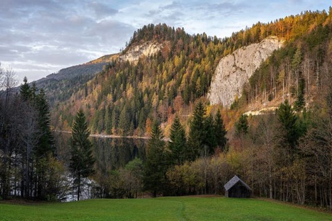 The Schwarzensee and surrounding mountains in autumn. Trees in autumn leaves. Sun and clouds. St.