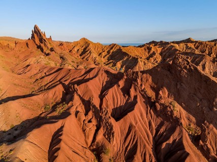 Aerial view, eroded mountain landscape, sandstone cliffs, canyon with red and orange rock