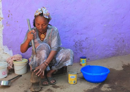 In the highlands of Abyssinia, in the village of Sina, young woman prepares coffee for the coffee