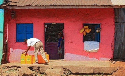 South Ethiopia, street scene in Jinka, yellow canisters in front of a pink house, Ethiopia, Africa