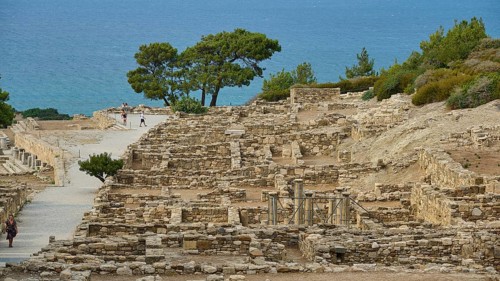 Remains of an ancient city overlooking the sea, surrounded by vegetation, Hellenistic houses,