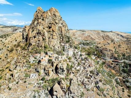 Mountains and Olive groves around Ghost Town from a drone, Pentedattilo Village, Calabria, Italy,