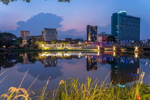 Chiang Mai skyline reflected in the Mae Nam Ping River at dusk, Chiang Mai, Thailand, Asia
