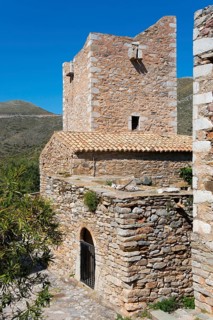 Detailed view of a traditionally built stone tower in a village landscape, residential tower,