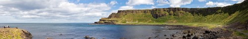 Coastal landscape with cliffs and sweeping sea views under a blue sky, Giant Causeway