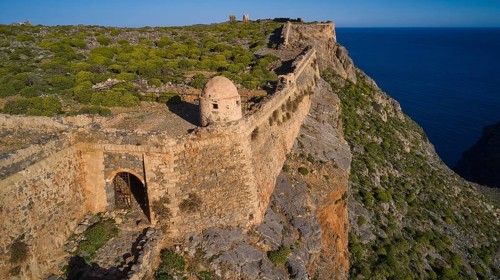 Drone shot, A stony section of a former fortress along a cliff edge overlooking the sea, Venetian