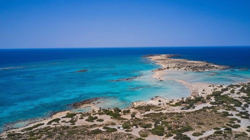 Overtourism, tourists on the beach, parasols, A sandy coast with turquoise sea, a popular nature
