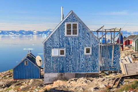 Typical Greenlandic house in an Inuit settlement on a fjord off Bergen, sunny, Ittoqqortoormiit,