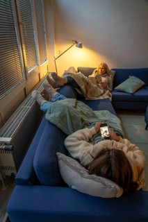 Symbolic image energy saving, cold winter, energy crisis, cold flat, mother and daughter lying on