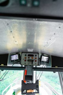 Screen system and control units on the ceiling of a modern control room, track construction Hermann