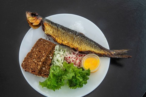 Traditional Bornholm dish: smoked fish, rye bread and vegetables in Gudhjem, Bornholm, Baltic Sea,