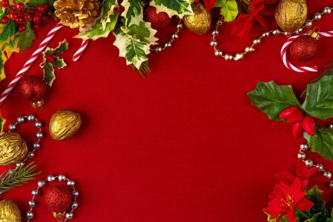 Christmas decoration frame with gold and red elements on a red background, copy room