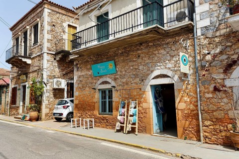 Typical stone houses with shops, souvenir shops, Stoupa, former fishing village, Mani, Greece,