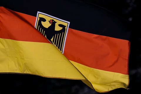 Symbolic photo. The national flag of the Federal Republic of Germany with a federal eagle