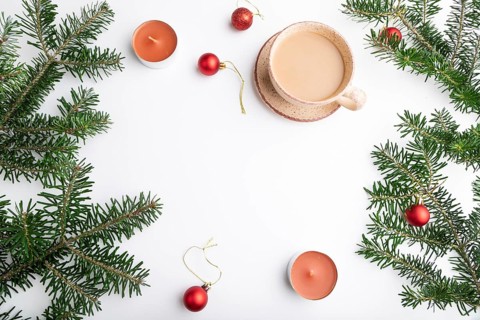 Christmas or New Year frame composition. Decorations, red balls, fir and spruce branches, cup of