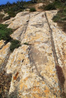 Prehistoric cart ruts tracks in limestone rock at Ta Cenc, Gozo, Malta, Europe