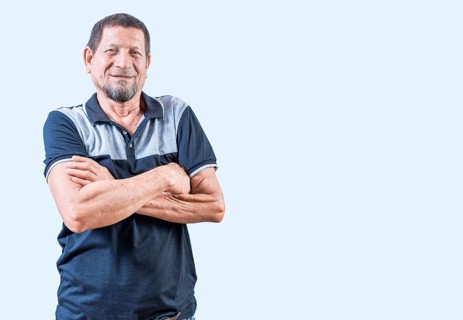 Portrait of smiling senior man with arms crossed isolated. Smiling latin old man with arms crossed,