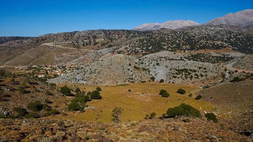 Plateau, panorama of a rural landscape with village and mountains in the background, Lefka Ori,