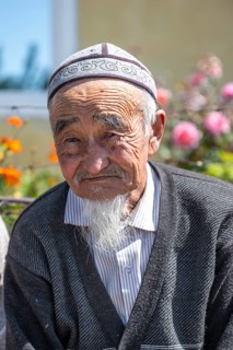 Portrait, local elderly man with traditional hat, Issyk-Kul region, Kyrgyzstan, Asia