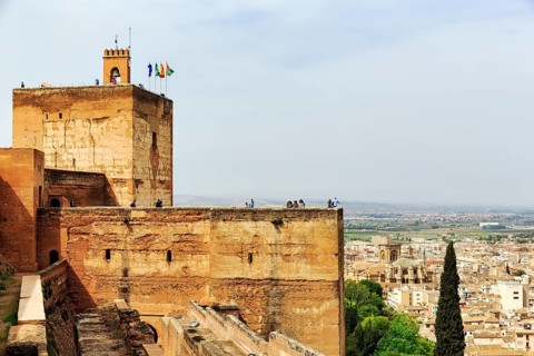 Watchtower with flags and tourists, Torre de la Vela, Alcazaba, Alhambra, Granada, Andalusia,