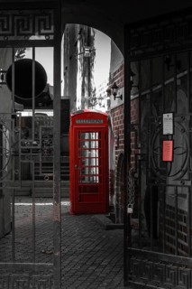 Old red phone booth in the courtyard