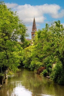 River Lemene with view of the cathedral of S. Andrea APostolo, medieval old town, Portogruaro,