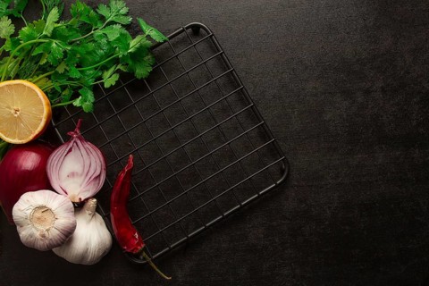 Food concept, black table, hot plate, spices, top view, no people horizontal