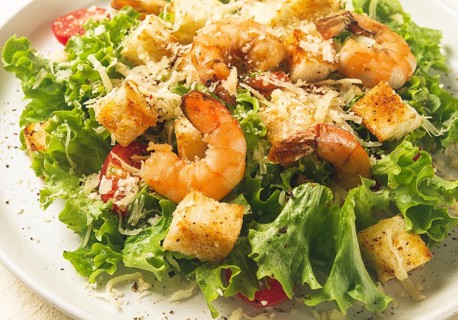Caesar salad, with shrimp, on a white background, homemade, no people