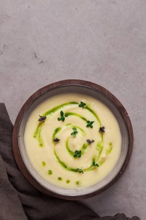 Mashed potatoes, with green butter and micro greenery, homemade, on a beige table, no people, top
