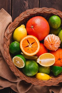 Assortment, citrus fruits, in a basket, close-up, top view, no people