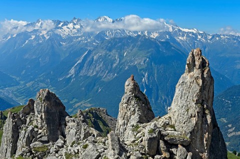View over rocky outcrops on the slopes of the Pierre Avoi summit to the mountain range of the Savoy