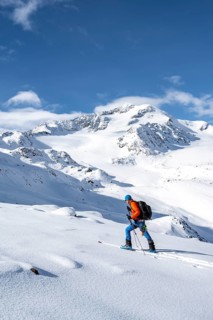 Ski tourers in a snow-covered mountain landscape, mountain peak Monte Cevedale and glacier